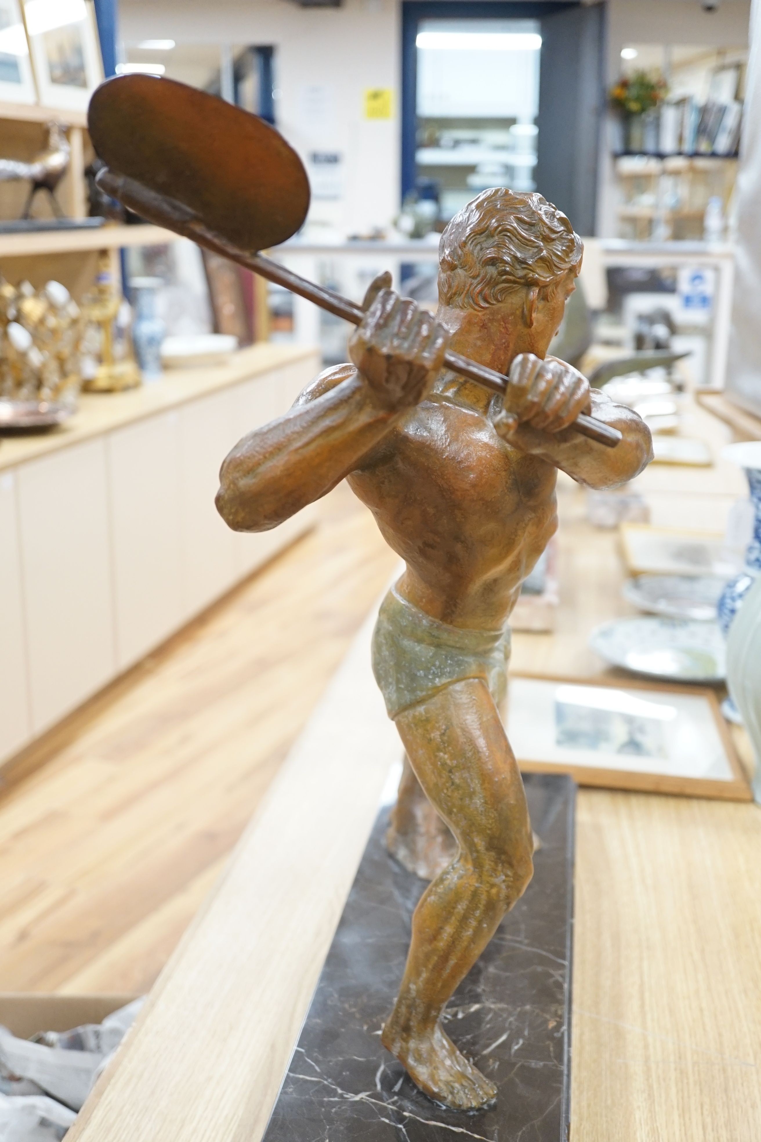 An Art Deco bronzed metal woodcutter, signed G Hervore, 75cm long